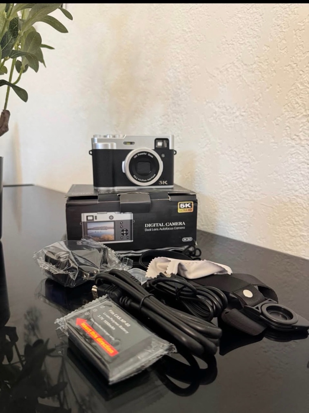 Compact Black and Silver Digital Camera with Accessories